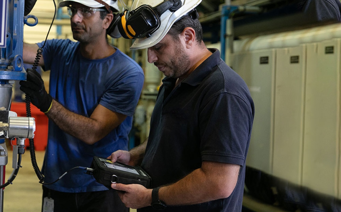 Workers near heavy machine